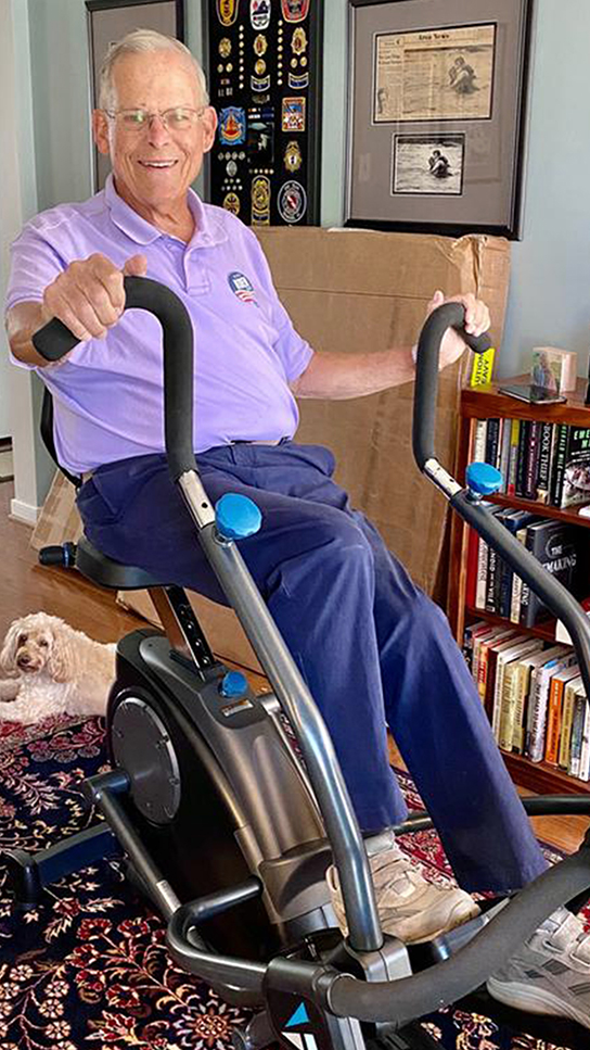 Teeter FreeStep Feel‑Good Exercise Club - Person on FreeStep in Home Office with dog