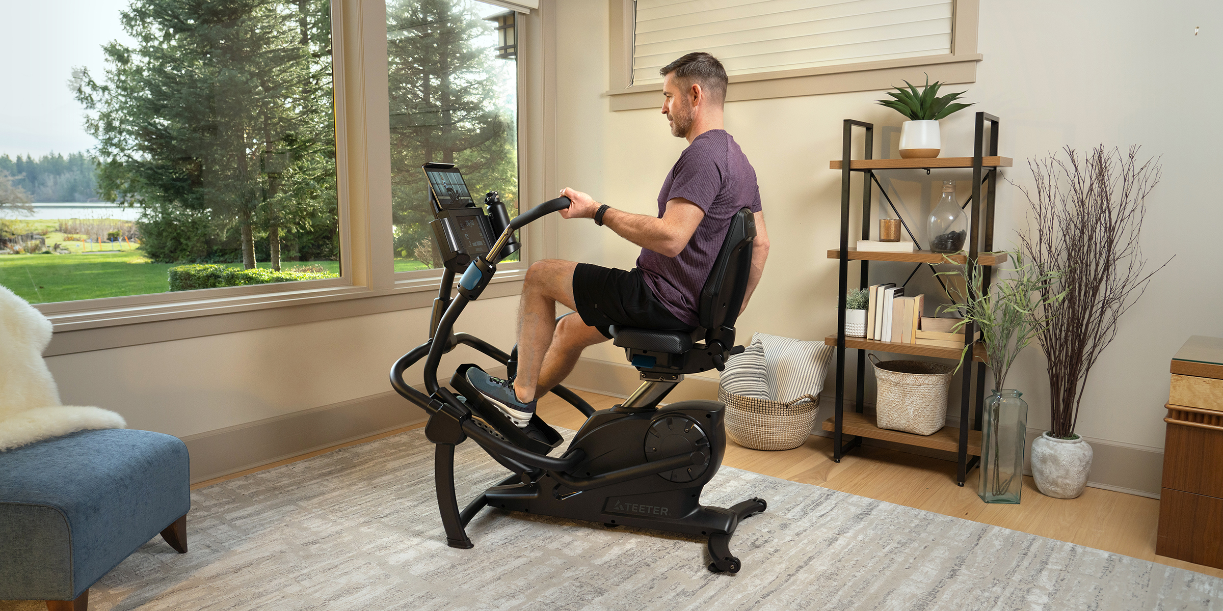 A man is engaged in a workout on a FreeStep Recumbent Cross Trainer within a well-furnished room.