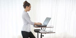 Woman working at a standing desk.