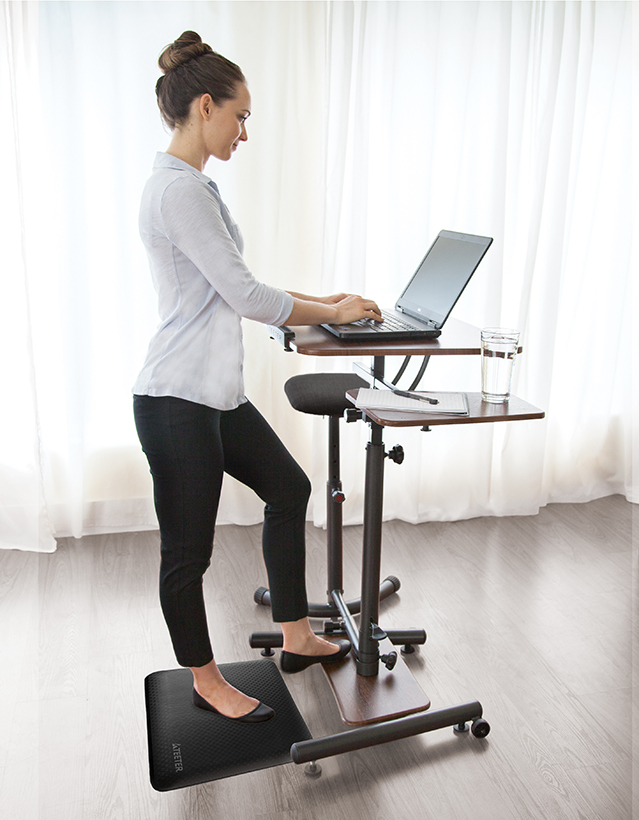 Woman standing at Teeter CoreWorks Sit Stand Desk