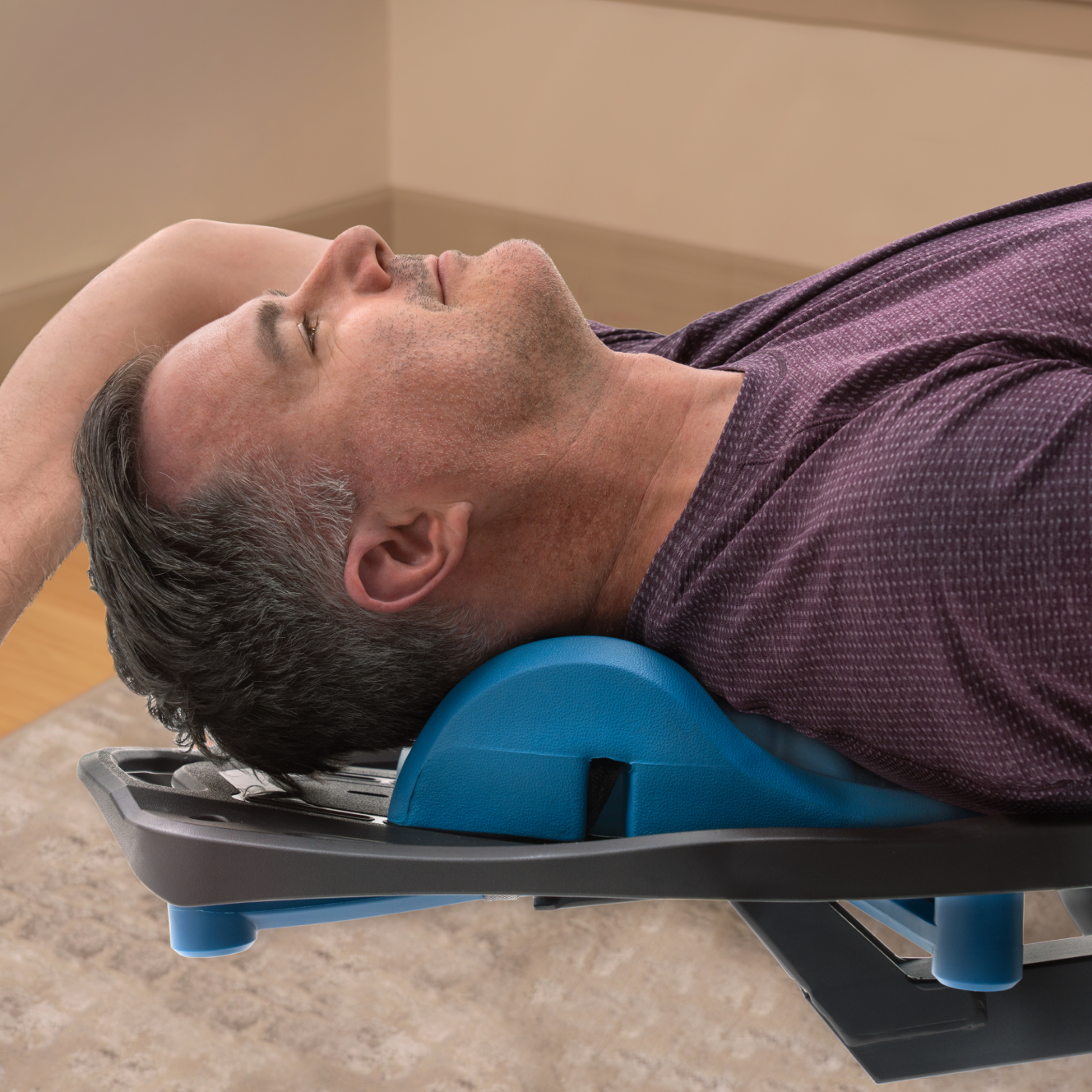 Person using the Teeter Myotrak on an inversion table